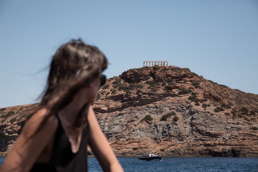 Girl looking at the temple of Poseidon during Terra Nation beach picnic